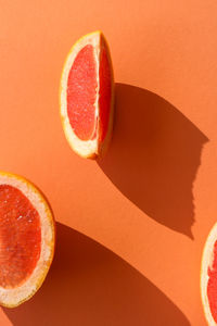 Close-up of strawberry on table against orange background