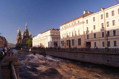 View of buildings against clear blue sky