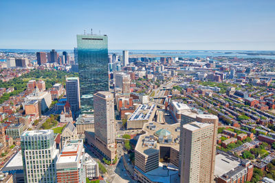 High angle view of modern buildings in city against clear sky