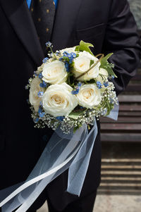 Close-up of rose holding bouquet of white roses