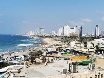 High angle view of buildings by sea against sky