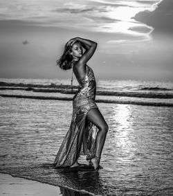 Portrait of young woman against sea against sky