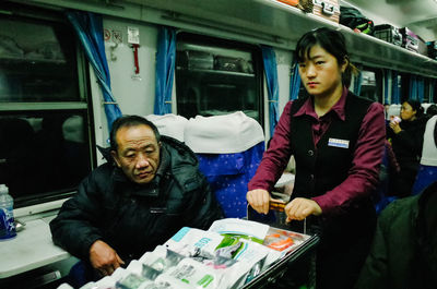 Full length of man sitting in train