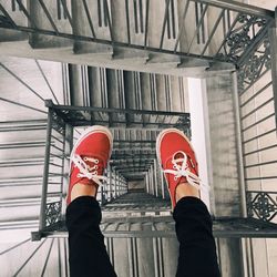 Low section of person legs over spiral staircase