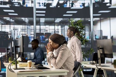 Side view of woman using mobile phone in cafe