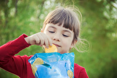 Close-up of girl blowing bubbles