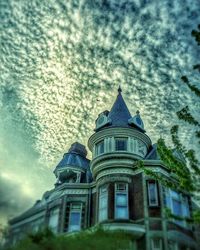 Low angle view of built structure against cloudy sky