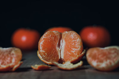 Close-up of fruits on table against black background