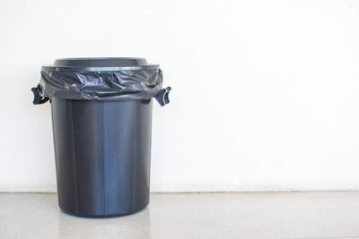 Close-up of garbage can against white background