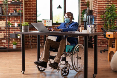 Man using laptop at cafe