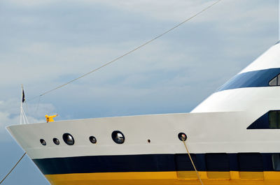 Cropped image of boat against cloudy sky