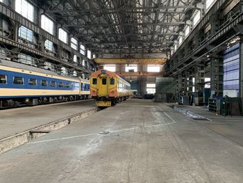 Train on railroad tracks amidst buildings in city