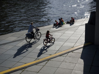 High angle view of people riding bicycle in city