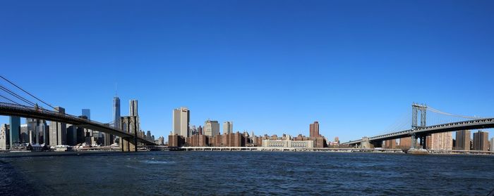 View of suspension bridge with city in background