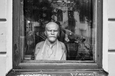 Portrait of man on glass window