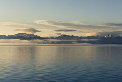 Scenic view of lake against sky during sunset