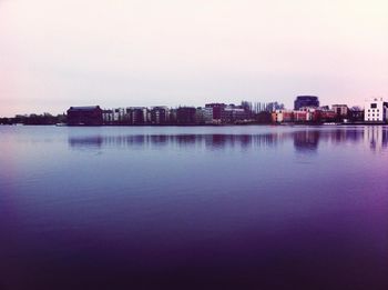 Scenic view of sea by city against sky