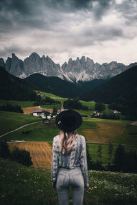 Rear view of woman standing against landscape