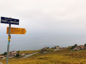 Road sign against sky