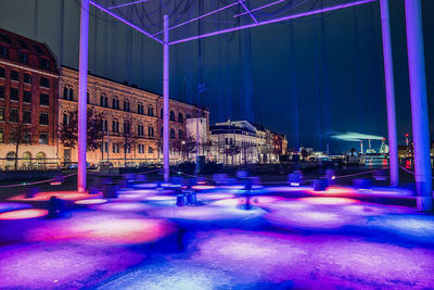 Illuminated city street at night