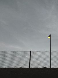 Fence on field against sky