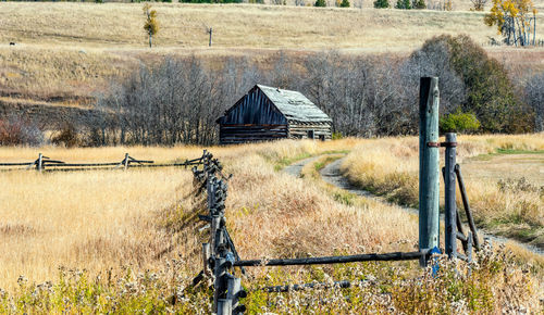 House on field by fence