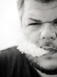 Close-up portrait of man smoking