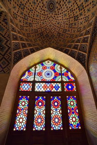 Low angle view of stained glass window in building