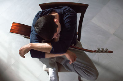 High angle view of boy playing piano at home