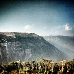 Scenic view of mountains against cloudy sky