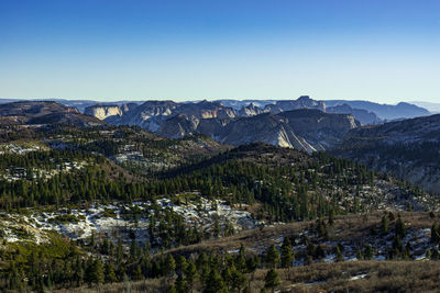 Scenic view of mountains against clear blue sky