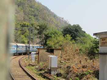 Train on railroad track amidst trees against sky