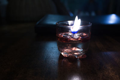 Close-up of lit tea light on table