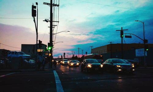 Traffic on road at sunset