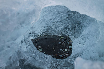 High angle view of frozen rock