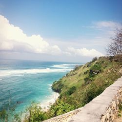 View of calm blue sea against cloudy sky