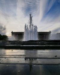 View of fountain against cloudy sky