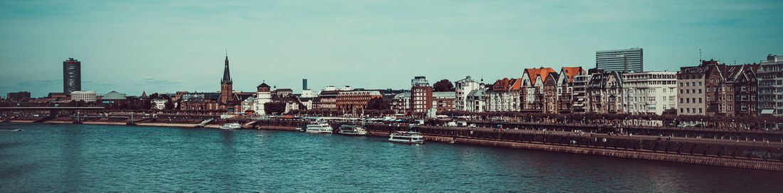 River amidst buildings against sky in city