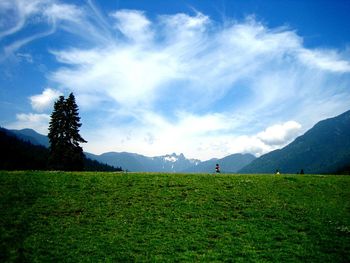 Scenic view of landscape against cloudy sky