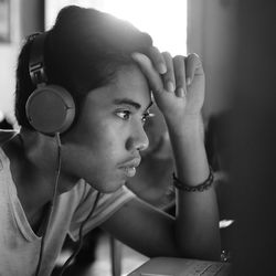 Close-up portrait of young woman looking away