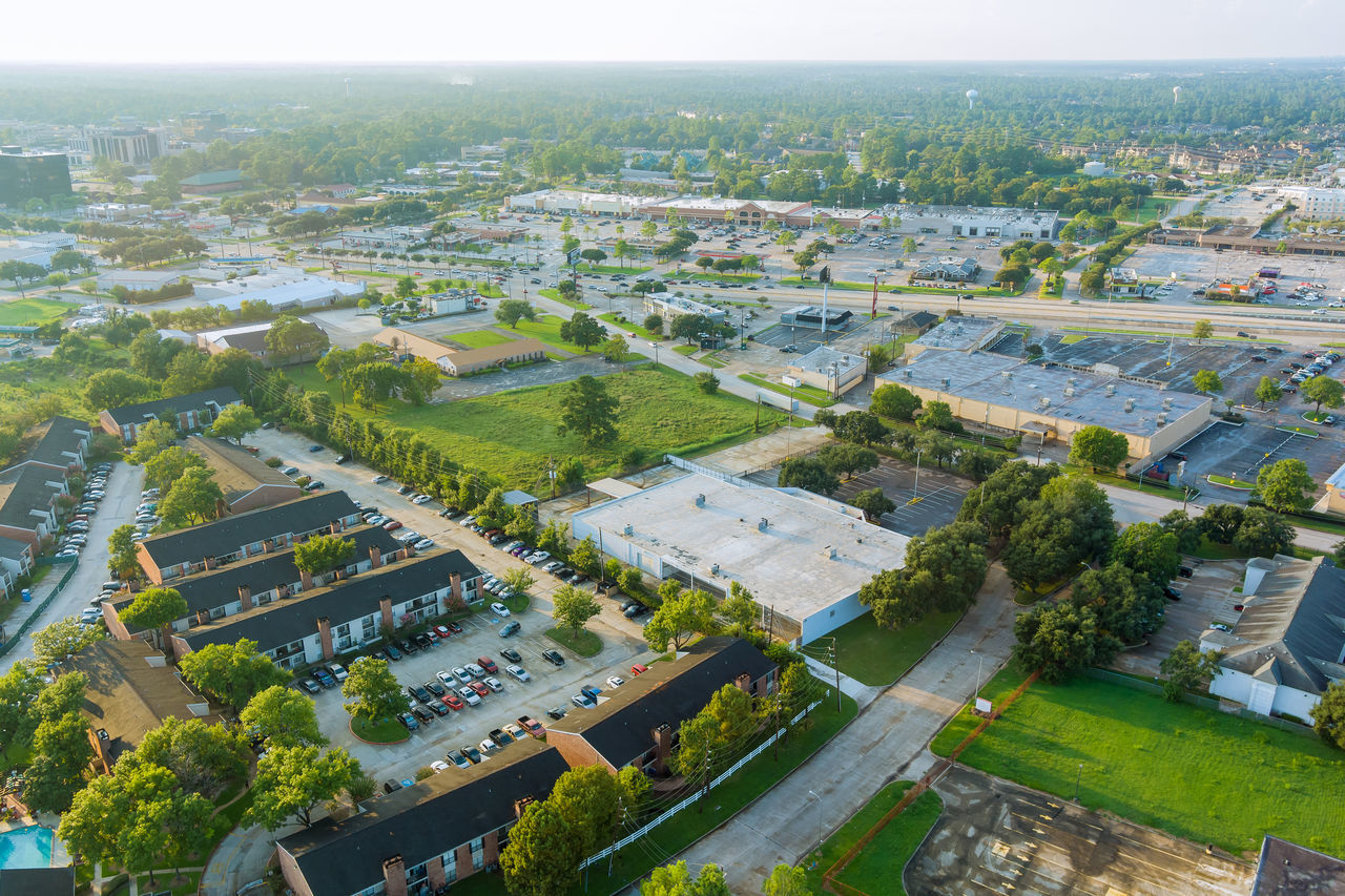 HIGH ANGLE VIEW OF STREET AMIDST BUILDINGS