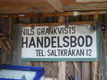 Close-up of text hanging on wood