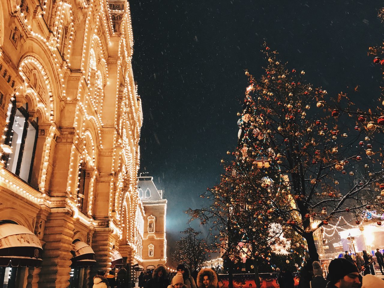 night, illuminated, architecture, tree, built structure, building exterior, celebration, plant, city, building, religion, group of people, decoration, crowd, large group of people, nature, christmas, men, sky, outdoors