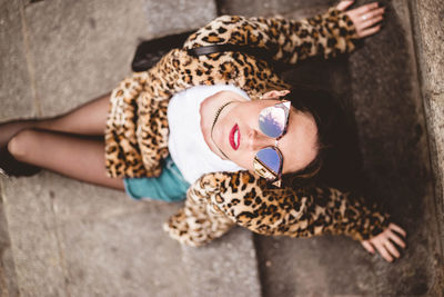 High angle view of woman lying down on bed