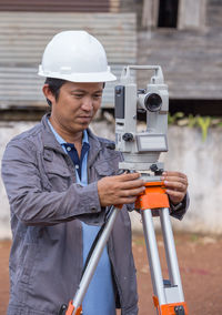 Man photographing with umbrella working