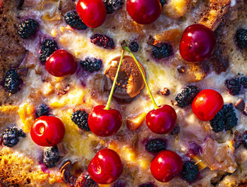 A cake decorated with two red cherries. homemade baking. 