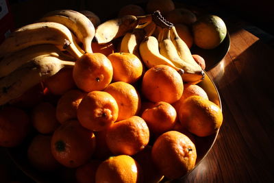 Close-up of tangerines and bananas