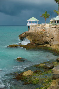 Scenic view of sea against buildings