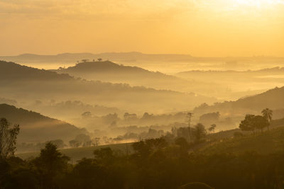 Scenic view of mountains against sky during sunrise