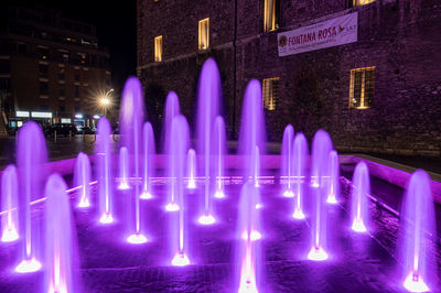 Panoramic view of illuminated building in city at night